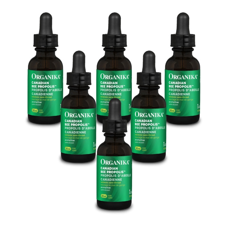 Six amber glass dropper bottles of Organika Canadian Bee Propolis tincture arranged on a plain white background. natvd