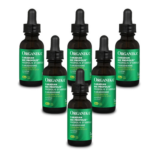 Six amber glass dropper bottles of Organika Canadian Bee Propolis tincture arranged on a plain white background. natvd